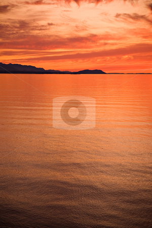 To use this stock image in your creative project, please select the size you need over to the right and click the "Add to Cart" button.
Your downloaded image will come with the Cutcaster watermark removed so don’t worry about the watermark you see on this page. Strait of Juan de Fuca Sunset stock photo, A beautiful sunset over the Strait of Juan de Fuca in Sequim, Washington. by Travis Manley