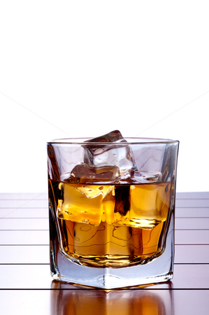 To use this stock image in your creative project, please select the size you need over to the right and click the "Add to Cart" button.
Your downloaded image will come with the Cutcaster watermark removed so don’t worry about the watermark you see on this page. A vertical image of a glass of whiskey with ice on a wooden bar stock photo, A vertical image of a glass of whiskey with ice on a wooden bar table with a white background and space for copy by Vince Clements