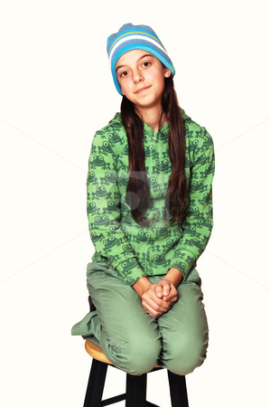 To use this stock image in your creative project, please select the size you need over to the right and click the "Add to Cart" button.
Your downloaded image will come with the Cutcaster watermark removed so don’t worry about the watermark you see on this page. Teenager kneeling on chair. stock photo, Girl dressed all in green with long brown hair and blue cap kneeling
on a bar chair for white background. by Horst Petzold