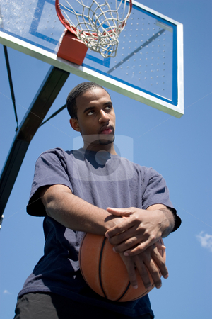 To use this stock image in your creative project, please select the size you need over to the right and click the "Add to Cart" button.
Your downloaded image will come with the Cutcaster watermark removed so don’t worry about the watermark you see on this page. Basketball Player Thinking stock photo, Young African American man posing with a basketball underneath the backboard. by Todd Arena