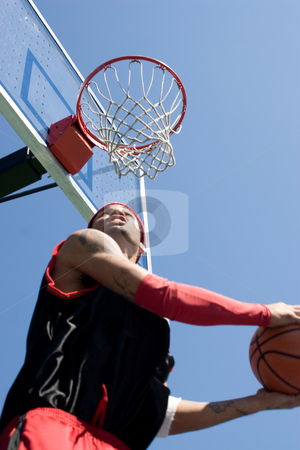 To use this stock image in your creative project, please select the size you need over to the right and click the "Add to Cart" button.
Your downloaded image will come with the Cutcaster watermark removed so don’t worry about the watermark you see on this page. Basketball Player Dunking stock photo, A young basketball player under the rim going for a reverse slam dunk. Shallow depth of field with stronger focus on the goal. by Todd Arena