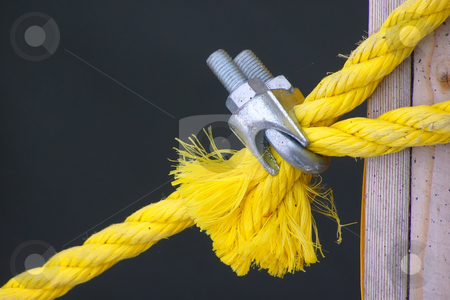 To use this stock image in your creative project, please select the size you need over to the right and click the "Add to Cart" button.
Your downloaded image will come with the Cutcaster watermark removed so don’t worry about the watermark you see on this page. Lashing stock photo, A yellow rope for a tie-down is clamped by metallic fastening by Sergej Razvodovskij