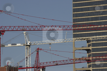 To use this stock image in your creative project, please select the size you need over to the right and click the "Add to Cart" button.
Your downloaded image will come with the Cutcaster watermark removed so don’t worry about the watermark you see on this page. Construction cranes stock photo, Three cranes operate during the construction of a building by Matt Baker