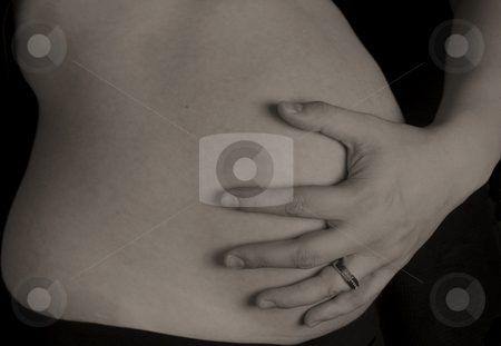 To use this stock image in your creative project, please select the size you need over to the right and click the "Add to Cart" button.
Your downloaded image will come with the Cutcaster watermark removed so don’t worry about the watermark you see on this page. Hands and Tummy stock photo, A husband holds his pregnant wifes stomach by Matt Baker