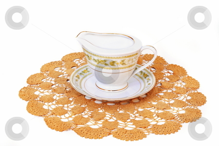 To use this stock image in your creative project, please select the size you need over to the right and click the "Add to Cart" button.
Your downloaded image will come with the Cutcaster watermark removed so don’t worry about the watermark you see on this page. Fine China stock photo, Fine China gravy server on hand crafted doily isolated on white background by Jack Schiffer