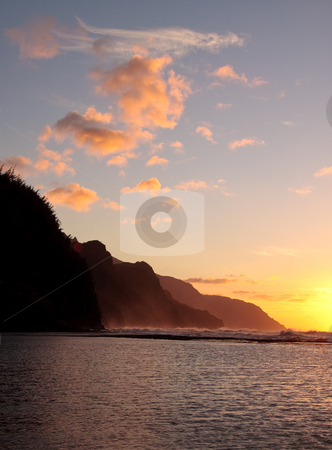 To use this stock image in your creative project, please select the size you need over to the right and click the "Add to Cart" button.
Your downloaded image will come with the Cutcaster watermark removed so don’t worry about the watermark you see on this page. Vertical sunset of Na Pali coastline on the island of Kauai stock photo, Vertical format of the headlands of the Kauai coast illuminated at sunset by Steven Heap