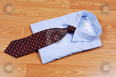 To use this stock image in your creative project, please select the size you need over to the right and click the "Add to Cart" button.
Your downloaded image will come with the Cutcaster watermark removed so don’t worry about the watermark you see on this page. Blue dress shirt with tie. stock photo, A light blue dress shirt on a wood surface with an red and black tie
for sale in the store. by Horst Petzold