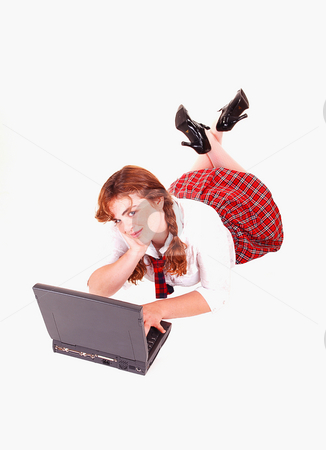 To use this stock image in your creative project, please select the size you need over to the right and click the "Add to Cart" button.
Your downloaded image will come with the Cutcaster watermark removed so don’t worry about the watermark you see on this page. Schoolgirl with laptop. stock photo, A young red haired schoolgirl in her uniform lying on the floor with the
laptop and thinking about her homework. by Horst Petzold