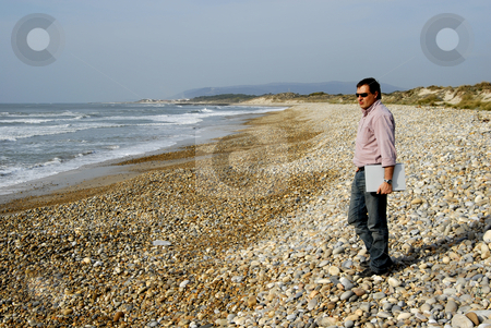 To use this stock image in your creative project, please select the size you need over to the right and click the "Add to Cart" button.
Your downloaded image will come with the Cutcaster watermark removed so don’t worry about the watermark you see on this page. Beach stock photo, Young man at the beach with his laptop by Rui Vale de Sousa