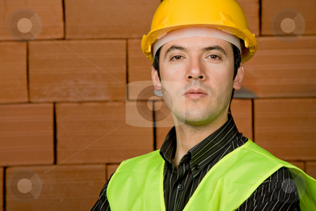 To use this stock image in your creative project, please select the size you need over to the right and click the "Add to Cart" button.
Your downloaded image will come with the Cutcaster watermark removed so don’t worry about the watermark you see on this page. Engineer stock photo, Engineer with yellow hat with a brick wall as background by Rui Vale de Sousa