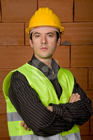 To use this stock image in your creative project, please select the size you need over to the right and click the "Add to Cart" button.
Your downloaded image will come with the Cutcaster watermark removed so don’t worry about the watermark you see on this page. Engineer stock photo, Engineer with yellow hat with a brick wall as background by Rui Vale de Sousa