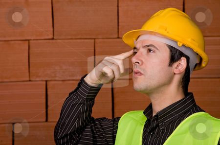 To use this stock image in your creative project, please select the size you need over to the right and click the "Add to Cart" button.
Your downloaded image will come with the Cutcaster watermark removed so don’t worry about the watermark you see on this page. Engineer stock photo, Engineer with yellow hat with a brick wall as background by Rui Vale de Sousa