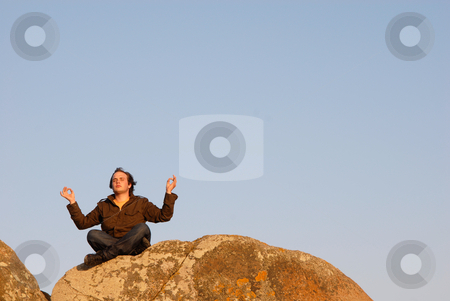 To use this stock image in your creative project, please select the size you need over to the right and click the "Add to Cart" button.
Your downloaded image will come with the Cutcaster watermark removed so don’t worry about the watermark you see on this page. Yoga stock photo, Young man meditating on the rocks with the sky as background by Rui Vale de Sousa