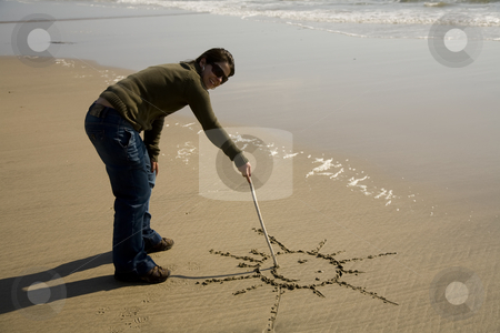 To use this stock image in your creative project, please select the size you need over to the right and click the "Add to Cart" button.
Your downloaded image will come with the Cutcaster watermark removed so don’t worry about the watermark you see on this page. Drawing stock photo, Young woman drawing a sun at the beach by Rui Vale de Sousa