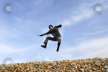 To use this stock image in your creative project, please select the size you need over to the right and click the "Add to Cart" button.
Your downloaded image will come with the Cutcaster watermark removed so don’t worry about the watermark you see on this page. Jump stock photo, Young man jumps on beach, with the sky as background by Rui Vale de Sousa