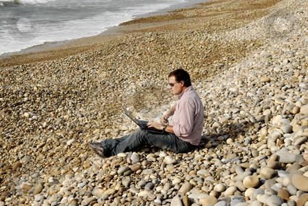 To use this stock image in your creative project, please select the size you need over to the right and click the "Add to Cart" button.
Your downloaded image will come with the Cutcaster watermark removed so don’t worry about the watermark you see on this page. Working stock photo, Young casual man with laptop at the beach by Rui Vale de Sousa