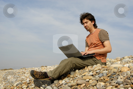 To use this stock image in your creative project, please select the size you need over to the right and click the "Add to Cart" button.
Your downloaded image will come with the Cutcaster watermark removed so don’t worry about the watermark you see on this page. Working stock photo, Young casual man with laptop at the beach by Rui Vale de Sousa