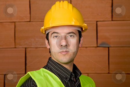 To use this stock image in your creative project, please select the size you need over to the right and click the "Add to Cart" button.
Your downloaded image will come with the Cutcaster watermark removed so don’t worry about the watermark you see on this page. Engineer stock photo, Engineer with yellow hat with a brick wall as background by Rui Vale de Sousa