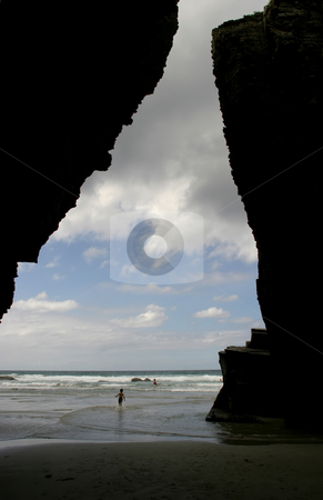 To use this stock image in your creative project, please select the size you need over to the right and click the "Add to Cart" button.
Your downloaded image will come with the Cutcaster watermark removed so don’t worry about the watermark you see on this page. Beach stock photo, Beach cave with some kids in the water by Rui Vale de Sousa