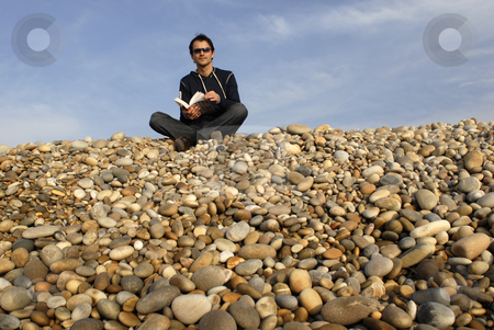 To use this stock image in your creative project, please select the size you need over to the right and click the "Add to Cart" button.
Your downloaded image will come with the Cutcaster watermark removed so don’t worry about the watermark you see on this page. Beach stock photo, Young man with a book at the beach by Rui Vale de Sousa