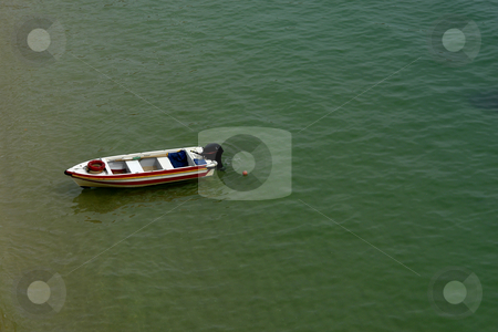 To use this stock image in your creative project, please select the size you need over to the right and click the "Add to Cart" button.
Your downloaded image will come with the Cutcaster watermark removed so don’t worry about the watermark you see on this page. Boat stock photo, Small woden boat at the green ocean water by Rui Vale de Sousa