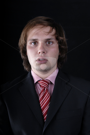 To use this stock image in your creative project, please select the size you need over to the right and click the "Add to Cart" button.
Your downloaded image will come with the Cutcaster watermark removed so don’t worry about the watermark you see on this page. Portrait stock photo, Young business man portrait on black background by Rui Vale de Sousa