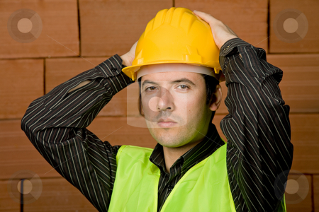 To use this stock image in your creative project, please select the size you need over to the right and click the "Add to Cart" button.
Your downloaded image will come with the Cutcaster watermark removed so don’t worry about the watermark you see on this page. Engineer stock photo, Engineer with yellow hat with a brick wall as background by Rui Vale de Sousa