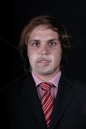 To use this stock image in your creative project, please select the size you need over to the right and click the "Add to Cart" button.
Your downloaded image will come with the Cutcaster watermark removed so don’t worry about the watermark you see on this page. Portrait stock photo, Young business man portrait on black background by Rui Vale de Sousa