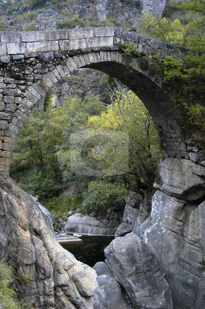 To use this stock image in your creative project, please select the size you need over to the right and click the "Add to Cart" button.
Your downloaded image will come with the Cutcaster watermark removed so don’t worry about the watermark you see on this page. Bridge stock photo, Ancient portuguese bridge by Rui Vale de Sousa