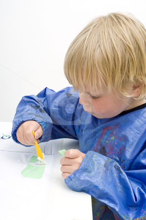 To use this stock image in your creative project, please select the size you need over to the right and click the "Add to Cart" button.
Your downloaded image will come with the Cutcaster watermark removed so don’t worry about the watermark you see on this page. Pasting paper stock photo, Young boy pasing pieces of paper on a table by Corepics VOF