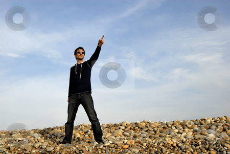 To use this stock image in your creative project, please select the size you need over to the right and click the "Add to Cart" button.
Your downloaded image will come with the Cutcaster watermark removed so don’t worry about the watermark you see on this page. Pointing stock photo, Young man alone pointing at the beach by Rui Vale de Sousa