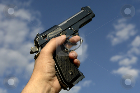 To use this stock image in your creative project, please select the size you need over to the right and click the "Add to Cart" button.
Your downloaded image will come with the Cutcaster watermark removed so don’t worry about the watermark you see on this page. Gun stock photo, Hand withe a gun and the sky as background by Rui Vale de Sousa