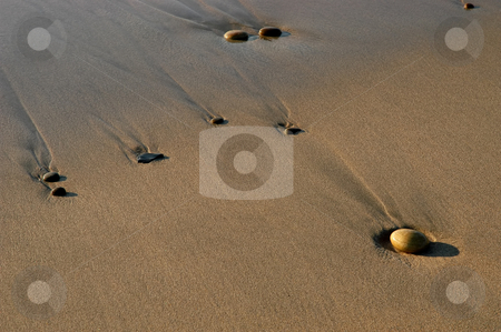 To use this stock image in your creative project, please select the size you need over to the right and click the "Add to Cart" button.
Your downloaded image will come with the Cutcaster watermark removed so don’t worry about the watermark you see on this page. Rocks stock photo, Rocks on the sand by Rui Vale de Sousa