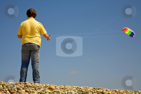 To use this stock image in your creative project, please select the size you need over to the right and click the "Add to Cart" button.
Your downloaded image will come with the Cutcaster watermark removed so don’t worry about the watermark you see on this page. Fly stock photo, Young man at the beach playing with the wind by Rui Vale de Sousa
