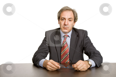 To use this stock image in your creative project, please select the size you need over to the right and click the "Add to Cart" button.
Your downloaded image will come with the Cutcaster watermark removed so don’t worry about the watermark you see on this page. Pensive stock photo, Mature business man on a desk, isolated on white by Rui Vale de Sousa