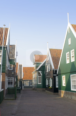 To use this stock image in your creative project, please select the size you need over to the right and click the "Add to Cart" button.
Your downloaded image will come with the Cutcaster watermark removed so don’t worry about the watermark you see on this page. Marken stock photo, The typical style Dutch fishermans' houses on the Peninsula of Marken. The quaint wooden gables, and the archetypal green and white paint in a deserted street during a summer evening. by Corepics VOF