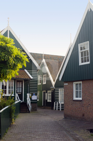 To use this stock image in your creative project, please select the size you need over to the right and click the "Add to Cart" button.
Your downloaded image will come with the Cutcaster watermark removed so don’t worry about the watermark you see on this page. Marken Chapel stock photo, An obscure, typica chapel in the center of Marken, a peninsula in the IJsselmeer, the Netherlands, with it's characteristical wooden gables by Corepics VOF