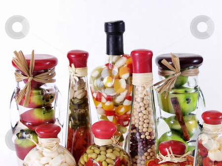 To use this stock image in your creative project, please select the size you need over to the right and click the "Add to Cart" button.
Your downloaded image will come with the Cutcaster watermark removed so don’t worry about the watermark you see on this page. Vinegar Bottles stock photo, A colorful assortment of pickled spices in different shaped jars on white. by Robert Gebbie