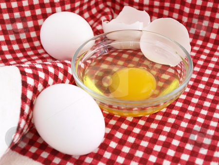 To use this stock image in your creative project, please select the size you need over to the right and click the "Add to Cart" button.
Your downloaded image will come with the Cutcaster watermark removed so don’t worry about the watermark you see on this page. Eggs on Red Cloth stock photo, An egg cracked into a dish, eggshells and whole eggs laying on a red checkered background. by Robert Gebbie