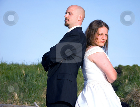 To use this stock image in your creative project, please select the size you need over to the right and click the "Add to Cart" button.
Your downloaded image will come with the Cutcaster watermark removed so don’t worry about the watermark you see on this page. Wedding Couple Fighting stock photo, This couple in their wedding clothes are fighting and having a argument, giving the cold shoulder. by Valerie Garner