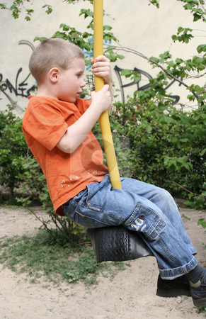 To use this stock image in your creative project, please select the size you need over to the right and click the "Add to Cart" button.
Your downloaded image will come with the Cutcaster watermark removed so don’t worry about the watermark you see on this page. On the playground stock photo, Young boy by Yvonne Bogdanski