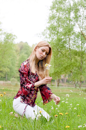 To use this stock image in your creative project, please select the size you need over to the right and click the "Add to Cart" button.
Your downloaded image will come with the Cutcaster watermark removed so don’t worry about the watermark you see on this page. Sweet girl with a flower stock photo, Young blond girl collecting flowers in the grass by Frenk and Danielle Kaufmann