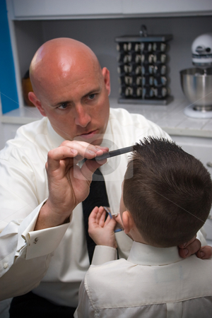 To use this stock image in your creative project, please select the size you need over to the right and click the "Add to Cart" button.
Your downloaded image will come with the Cutcaster watermark removed so don’t worry about the watermark you see on this page. Father Helping Son Get Ready stock photo, A groom helps his son get ready by doing his hair. by Todd Arena