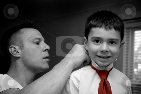 To use this stock image in your creative project, please select the size you need over to the right and click the "Add to Cart" button.
Your downloaded image will come with the Cutcaster watermark removed so don’t worry about the watermark you see on this page. Father Helping Son Get Ready stock photo, A groom helps his son get ready by putting on his tie. by Todd Arena