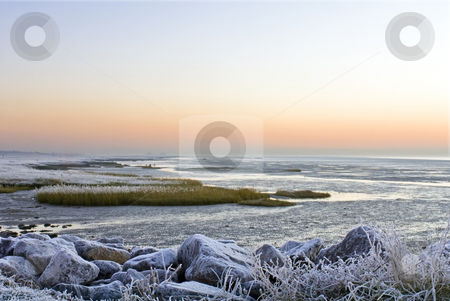 To use this stock image in your creative project, please select the size you need over to the right and click the "Add to Cart" button.
Your downloaded image will come with the Cutcaster watermark removed so don’t worry about the watermark you see on this page. Winter landscape stock photo, The frosted sea-side on the Westerschelde, Zeeland, the Netherlands early morning. by Corepics VOF