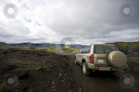 To use this stock image in your creative project, please select the size you need over to the right and click the "Add to Cart" button.
Your downloaded image will come with the Cutcaster watermark removed so don’t worry about the watermark you see on this page. Driving in Landmannarlaugar stock photo, An all terrain car emerging from the grim lava fields into the meadows of the beautiful Landmannalaugar national park in Iceland by Corepics VOF