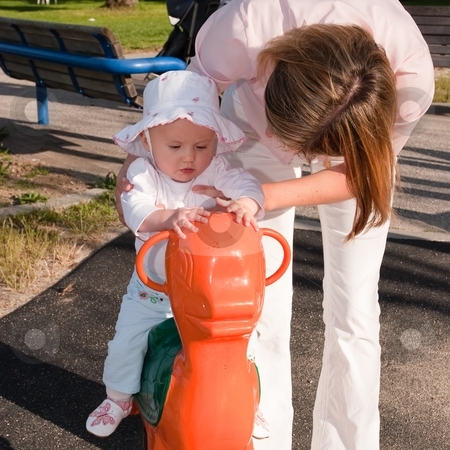 To use this stock image in your creative project, please select the size you need over to the right and click the "Add to Cart" button.
Your downloaded image will come with the Cutcaster watermark removed so don’t worry about the watermark you see on this page. Spring Horse stock photo, Portrait of a cute little caucasian baby girl and her mother having fun riding a spring horse by Mariusz Jurgielewicz