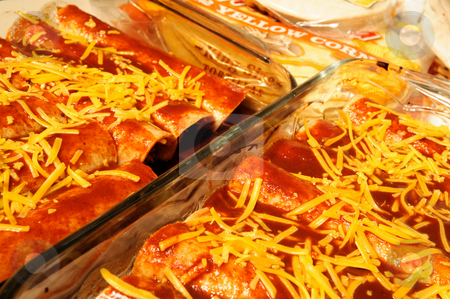 To use this stock image in your creative project, please select the size you need over to the right and click the "Add to Cart" button.
Your downloaded image will come with the Cutcaster watermark removed so don’t worry about the watermark you see on this page. Cheese Enchiladas stock photo, Homemade enchiladas ready to go in the oven, made with cheddar cheese, corn tortillas and pasilla chili enchilada sauce. by Lynn Bendickson