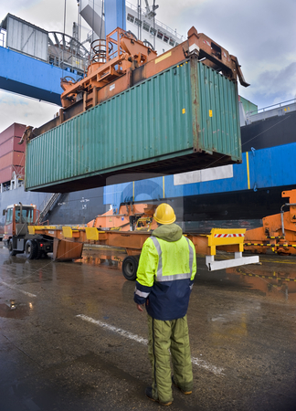To use this stock image in your creative project, please select the size you need over to the right and click the "Add to Cart" button.
Your downloaded image will come with the Cutcaster watermark removed so don’t worry about the watermark you see on this page. Container uploading stock photo, Worker supervising container uploading at dock by Noam Armonn