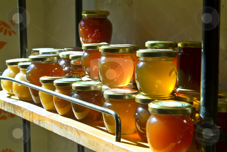 To use this stock image in your creative project, please select the size you need over to the right and click the "Add to Cart" button.
Your downloaded image will come with the Cutcaster watermark removed so don’t worry about the watermark you see on this page. Honey jars on a shelf stock photo, Many honey jars on a shelf in a warehouse by Noam Armonn